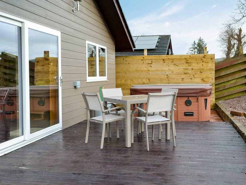 Tranquil patio with hot tub | Woodview - Cairnyard Holiday Lodges, Lochanhead, Beeswing