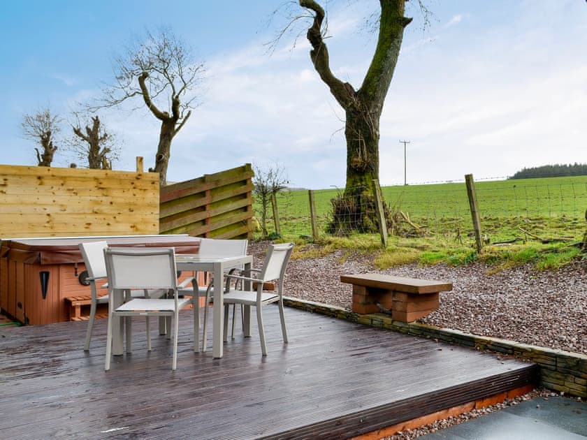 Tranquil patio with hot tub | Woodview - Cairnyard Holiday Lodges, Lochanhead, Beeswing