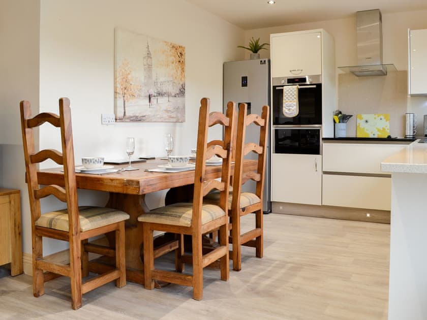 Dining and adjacent kitchen area | Woodedge - Cairnyard Holiday Lodges, Lochanhead, Beeswing