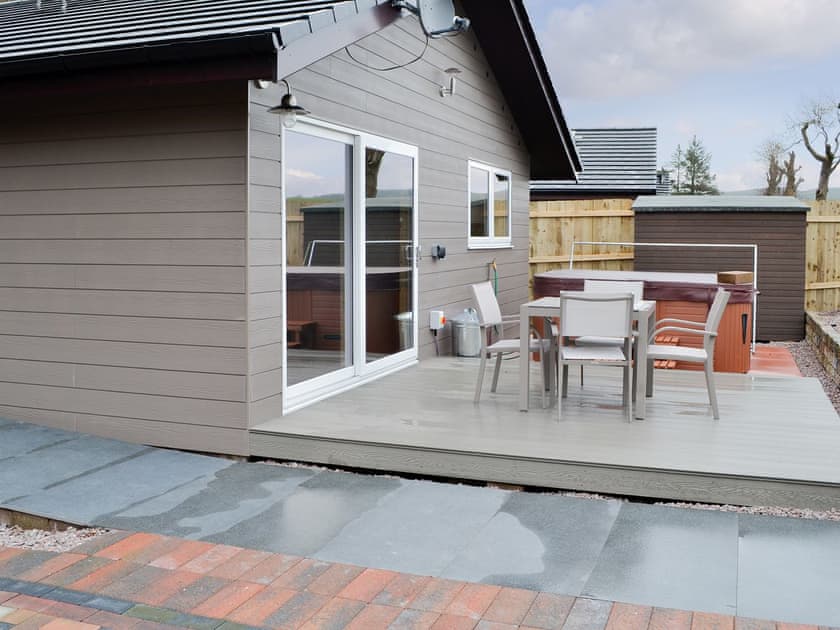 Patio area with ot tub and outdoor furniture | Woodedge - Cairnyard Holiday Lodges, Lochanhead, Beeswing