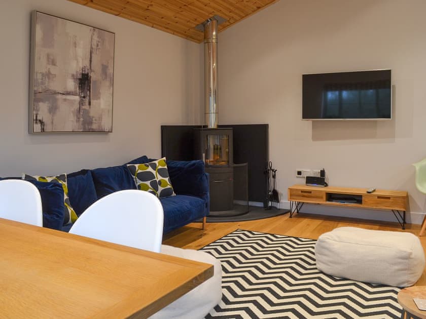 Comfortable lounge area with wood burner | Hen Harrier Lodge, St Columb Major, near Padstow