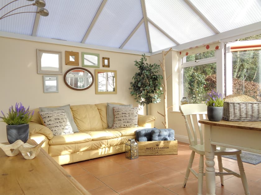 Comfy seating area within conservatory | The Old Winery Cottage, Newent