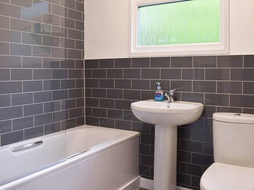 Tiled bathroom with shower over the bath | Chalet 7 - Mount Hawke Holiday Bungalows, Mount Hawke, near Redruth