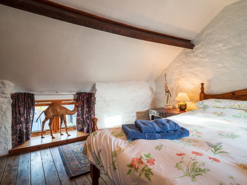 Wooden floored double bedroom with whitewashed walls | Buttermilk Cottage - The Old Dairy and Buttermilk Cottage, Youlgreave, near Bakewell