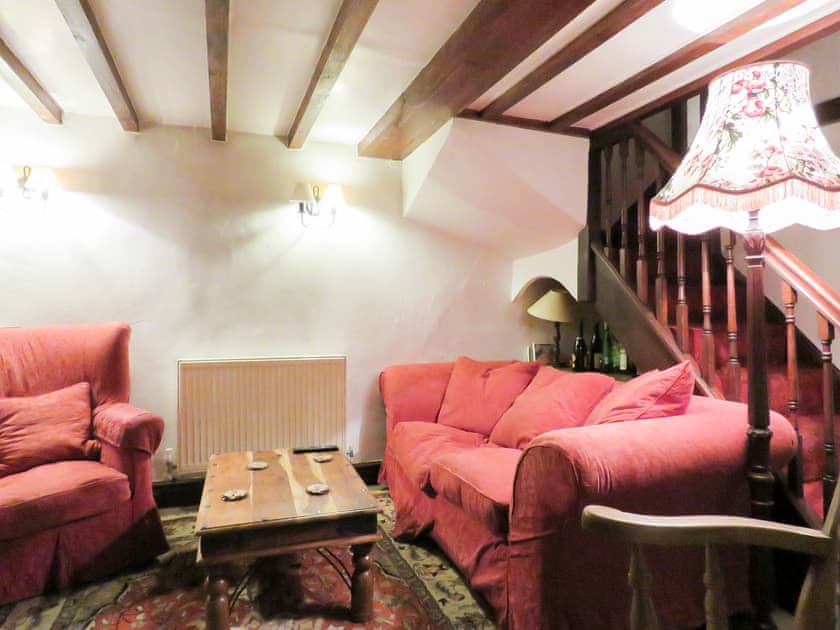 Beamed living room with staircase to the first floor | The Old Dairy - The Old Dairy and Buttermilk Cottage, Youlgreave, near Bakewell