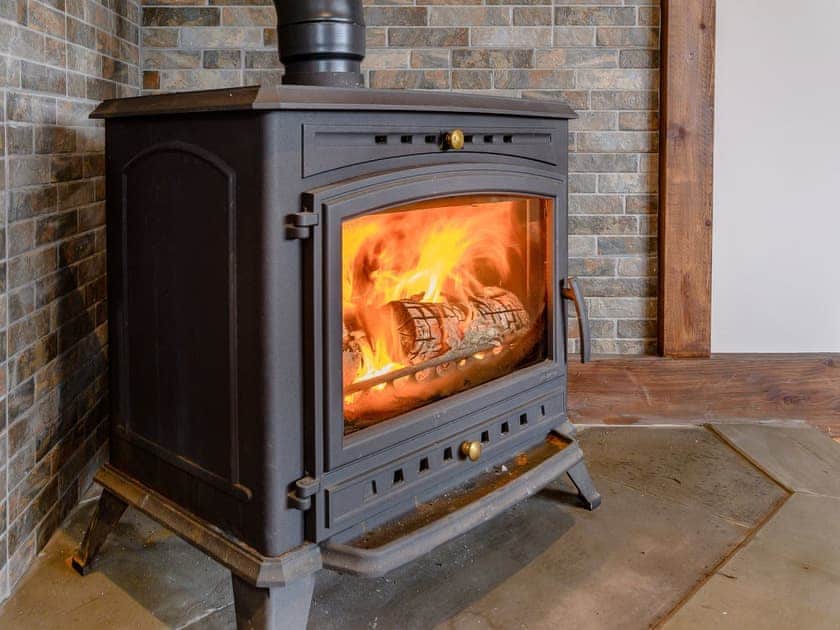 Warming wood burner | Olive Lodge, Melbourne, near Derby