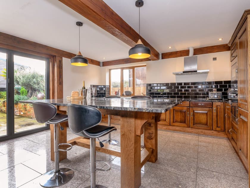 Light and airy kitchen with access to the rear patio and garden | Olive Lodge, Melbourne, near Derby