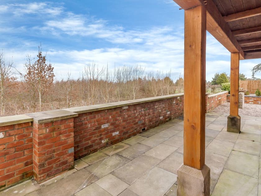 Paved patio accessed from the living area | Olive Lodge, Melbourne, near Derby