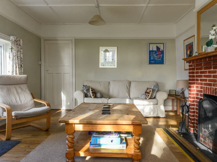 Welcoming living room with open fire | Riverside House, Beccles