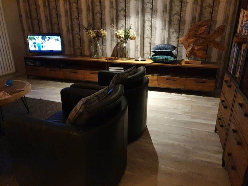 The cosy living room in the evening | Ferry Cottage, Pitlochry