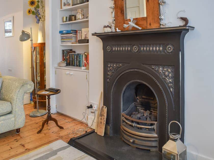 Warm and inviting living area with open fireplace | Blue Cottage, Broadstairs