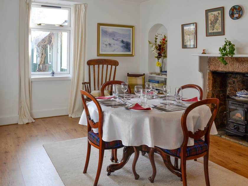 Elegant dining room with ornamental woodburner and traditional furniture | Craigclunie, Ballater