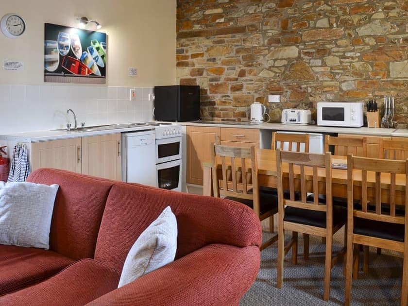 Exposed stone feature wall in the kitchen/dining area | Warren Cottage - Stowford Lodge Holiday Cottages, Langtree, near Great Torrington