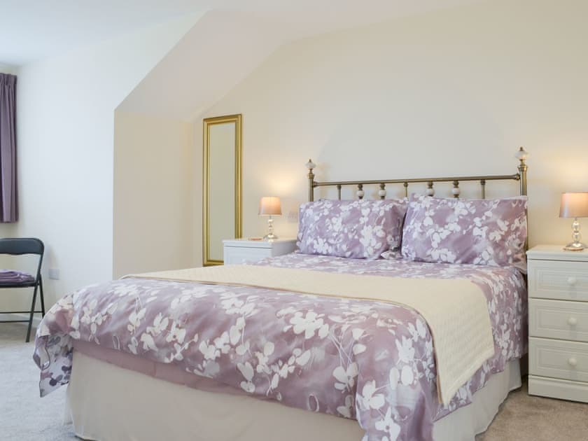 Beautiful bedroom with antique style bed | Driftwood, Port Isaac