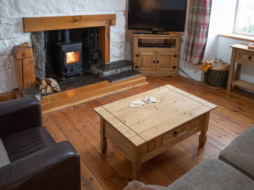 Welcoming living room with wood burner | Balloan Farm Cottage, Lairg