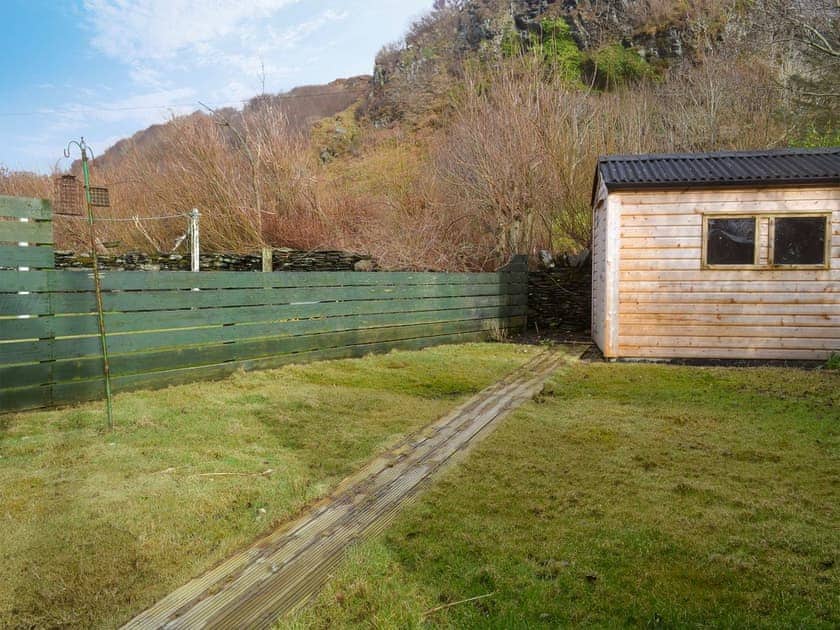 Small enclosed, lawned garden with garden furniture | Seaview Cottage, Ellenabeich, near Oban