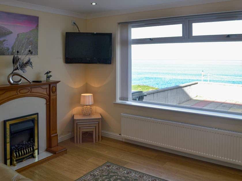 Living room with stunning sea views | Dolphin View - Scott Holiday Cottages, Portknockie