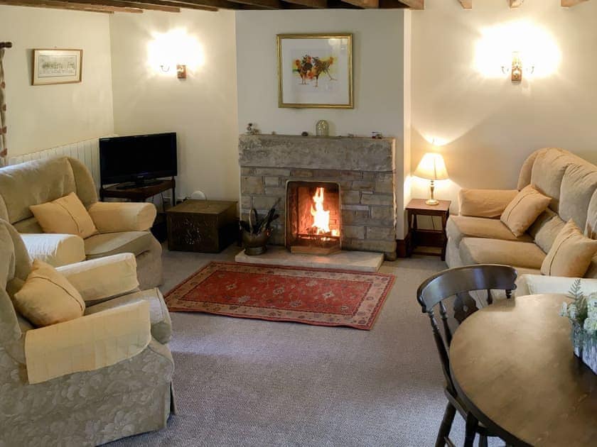 Living room with a cosy open fire | Ellerbeck Cottage - Swaledale and Ellerbeck Cottages, Caldbeck, near Keswick
