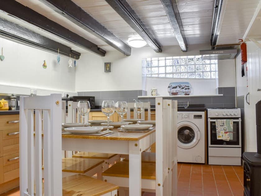 Kitchen/ dining room with beamed ceiling and electric wood burner | Cobblestones, Whitby