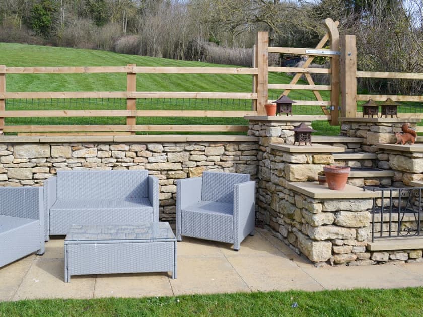 Seating area within the garden and steps and gated access to adjoining paddock | Forge Villa, Ebberston, near Pickering