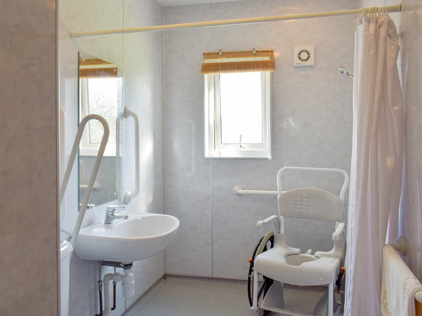 Wet room with walk-in shower, grab rails, hoist, toilet seat, shower seat and toilet | Willow Cottage - Culmore Bridge Cottages, Sandhead