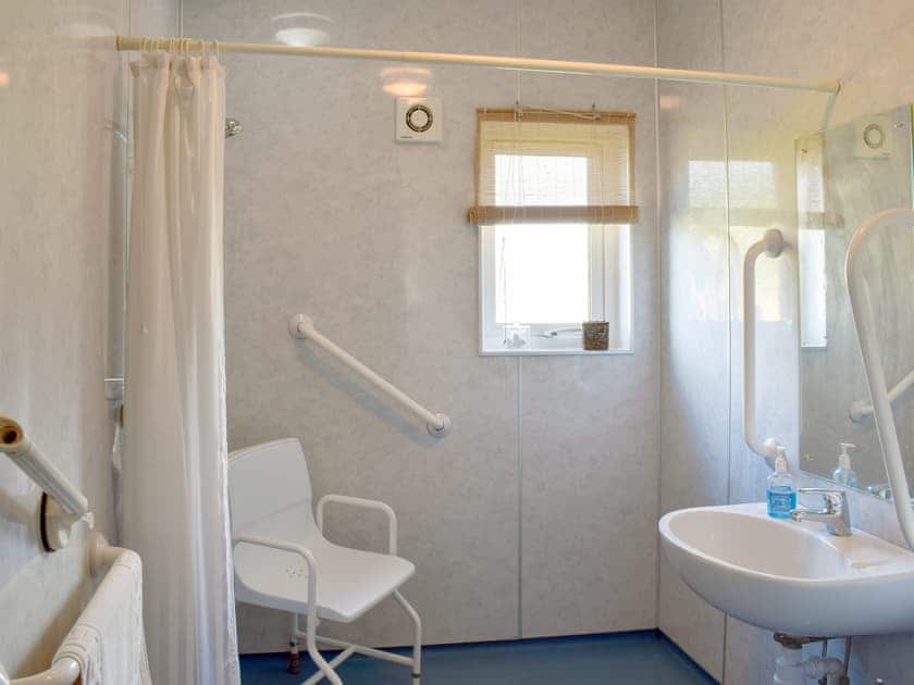 Wet room with shower, grab rails, hoist, adjustable toilet seat, shower seat and toilet. | Rowan Cottage - Culmore Bridge Cottages , Sandhead