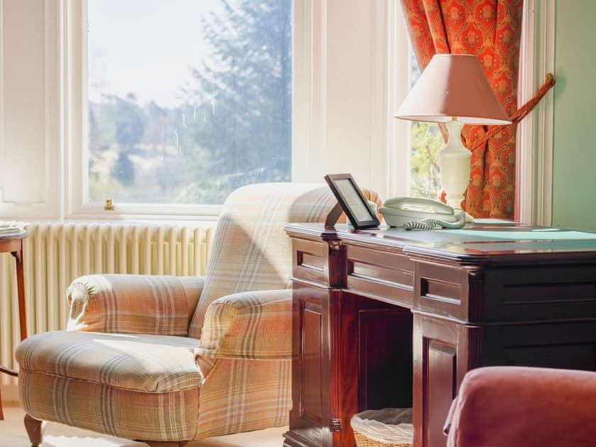 Characterful living room with open fire | Dalnaglar Castle - Dalnaglar Castle And Cottages, Glenshee, Cairngorms