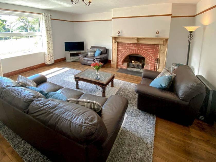 Welcoming living room with open fire | Penfound Country Cottage, Poundstock, near Bude