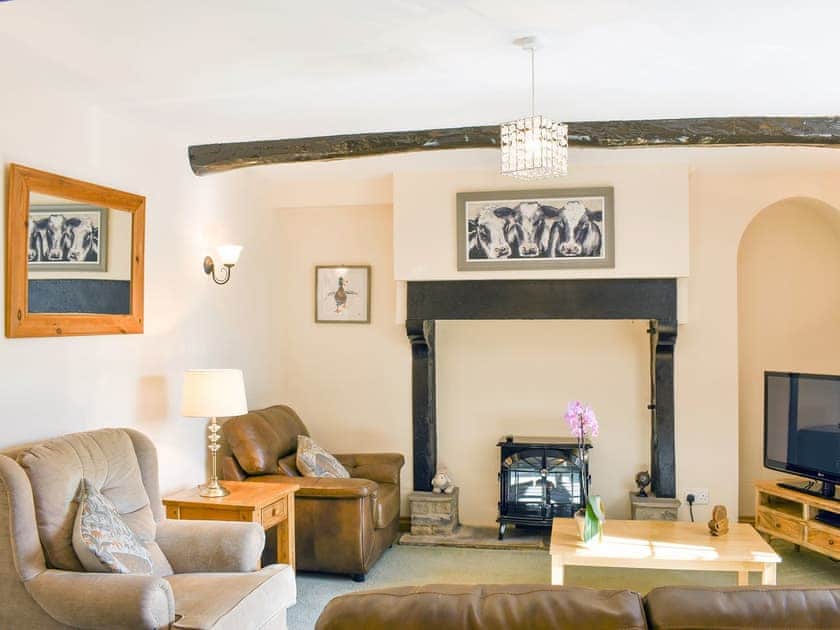 Spacious lounge with feature fireplace | Gran&rsquo;s Cottage, Askrigg
