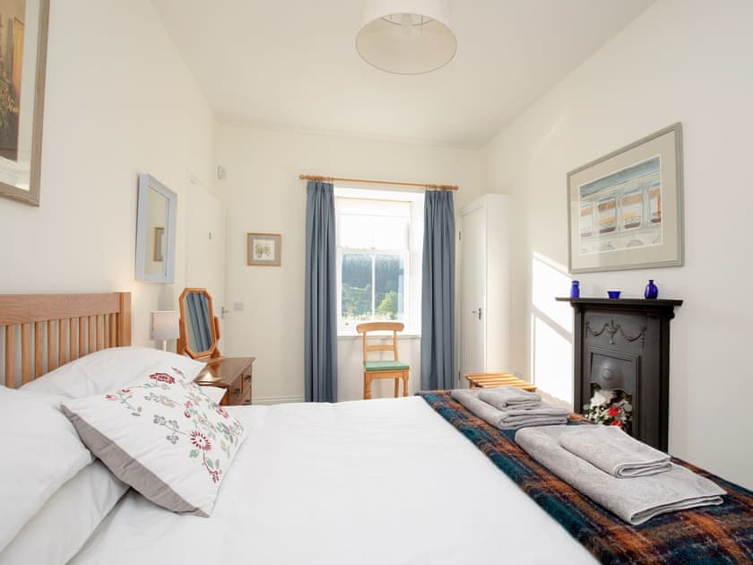 Relaxing double bedroom with feature fireplace | Nettlebush Cottage - Drumelzier Place Farm, Drumelzier, near Peebles