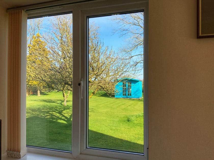 View of garden from sitting room | The Bungalow, Aikton, near Carlisle