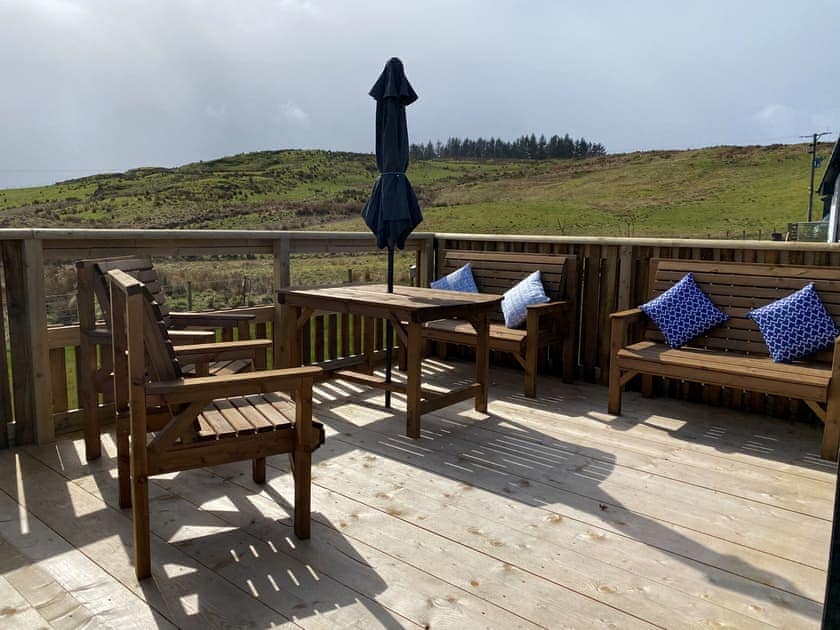 Large decked area to the front overlooking the surrounding fields and hills | Maggie’s Cabin, Oban