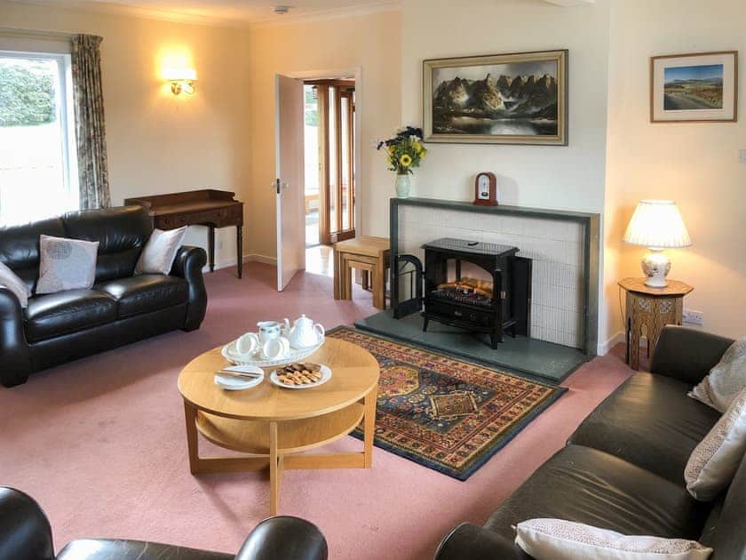Warm and cosy living room with &rsquo;log effect&rsquo; electric fire | Mountain Cross, Gatehouse of Fleet, Kirkcudbright
