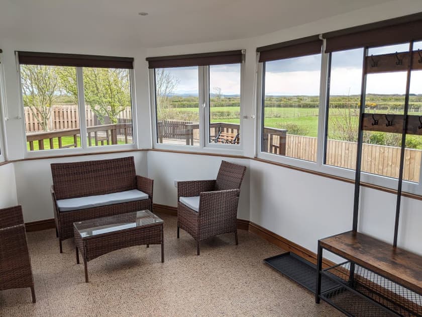 Conservatory with garden and countryside views | Brambleside, Mawbray near Allonby