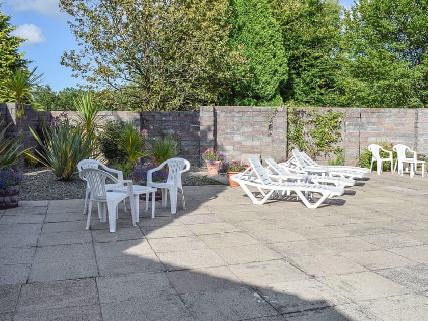 Pleasant patio area next to the shared pool | Oak Haven, Cenarth, near Newcastle Emlyn