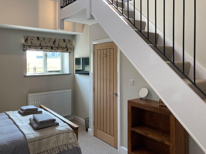 Double bedroom with access stairs to mezzanine | Tadpole Mews at Frog Hall, Tilston, near Malpas