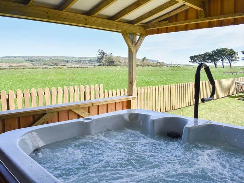 Relaxing hot tub with countryside views | Wisteria Cottage - Atherfield Green Farm Holiday Cottages, Chale, near Ventnor