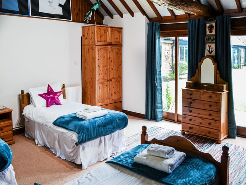 Look out for the peacocks and I see if your rugby or football team is represented in this room. | Lodge Farm Barn, South Walsham