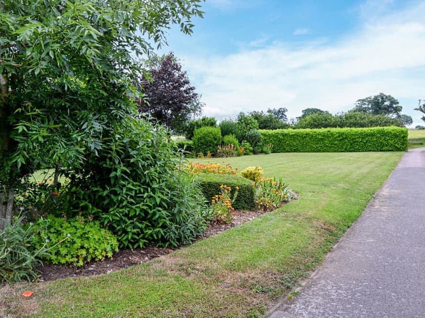 This is one of the outside lawns, and feel free to enjoy this space. | Lodge Farm Barn, South Walsham