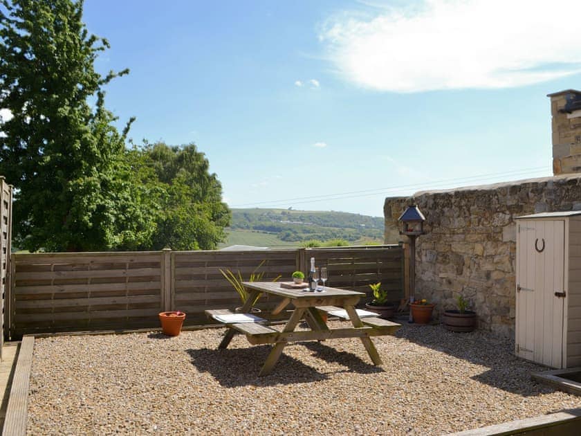 Patio to the rear of the holiday home | Dolly’s Cottage, Ovington