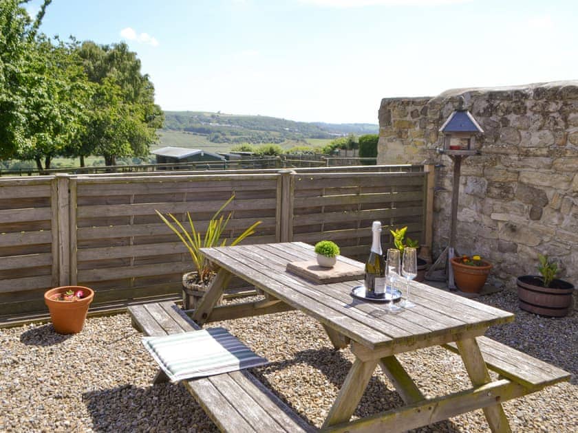 Patio to the rear of the holiday home | Dolly’s Cottage, Ovington