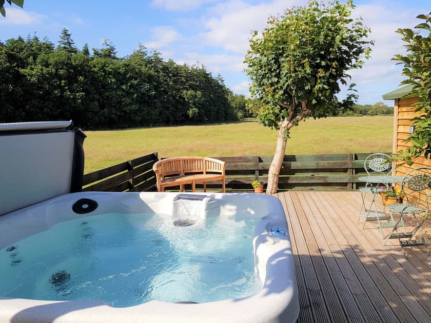 Large Hot tub which includes one lounger overlooking open fields and woodland. Ideal for enjoying Dumfries and Galloways | Trebor Cottage, Annan, near Dumfries