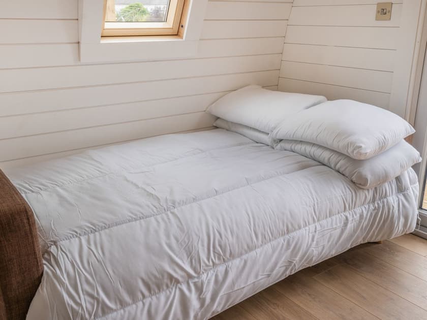 Living area converted to double bed sleeping area | Cwtch - Cwmporthman Farm, Blaenporth