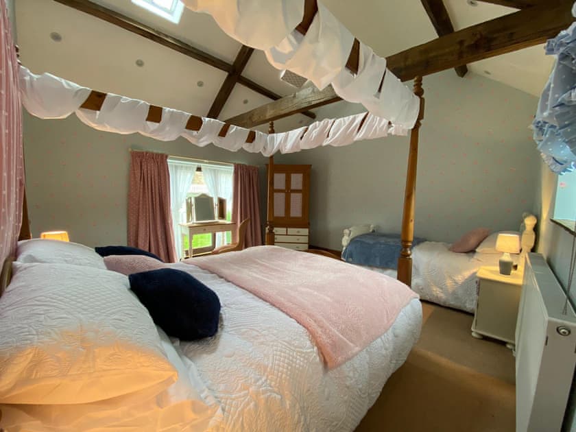 Family bedroom includes one kingsize four poster and one single bed  | Lily Rose Cottage, Gilsland, near Brampton