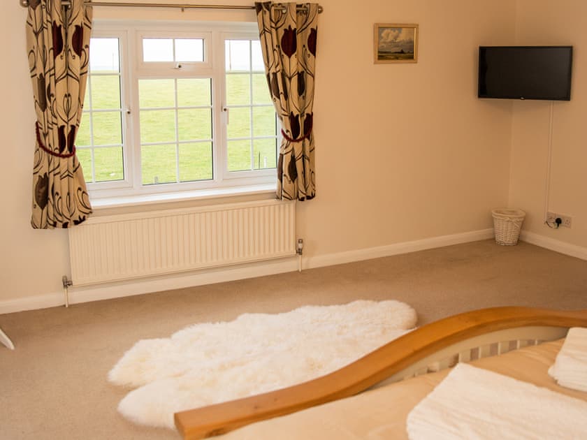 Spacious bedroom. Superking size bed. En-suite bathroom. Double aspect windows. Views over garden and across open countryside | Crickledown, High Ham, Langport