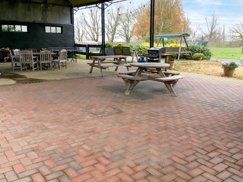 Covered BBQ and seating area | Heron - Caves Farm Barns, Near Ely