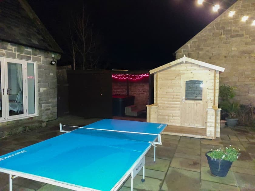 Nighttime view of the table tennis, hot tub and sauna | Woodside Cottage, Near Easington