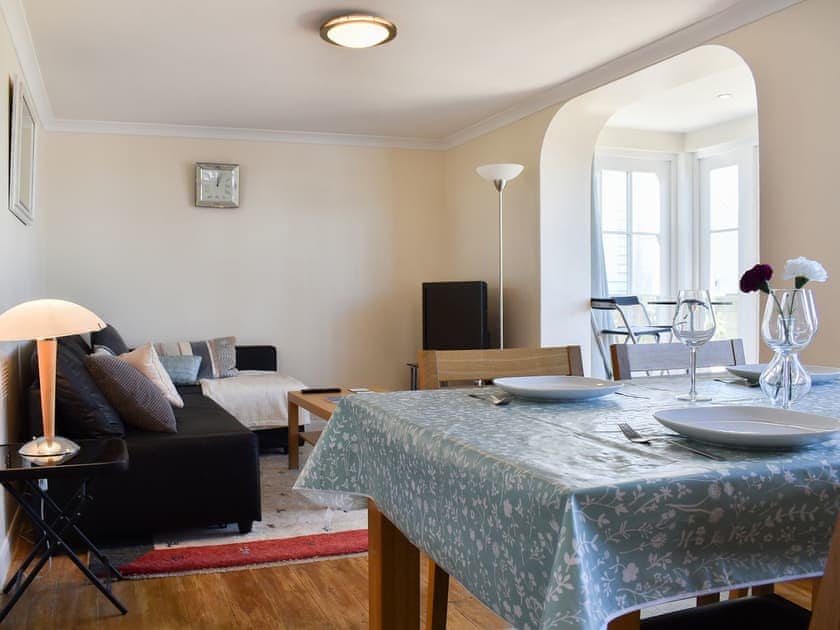 Living area and wooden-floored dining area | Oyster Cottage, Whitstable