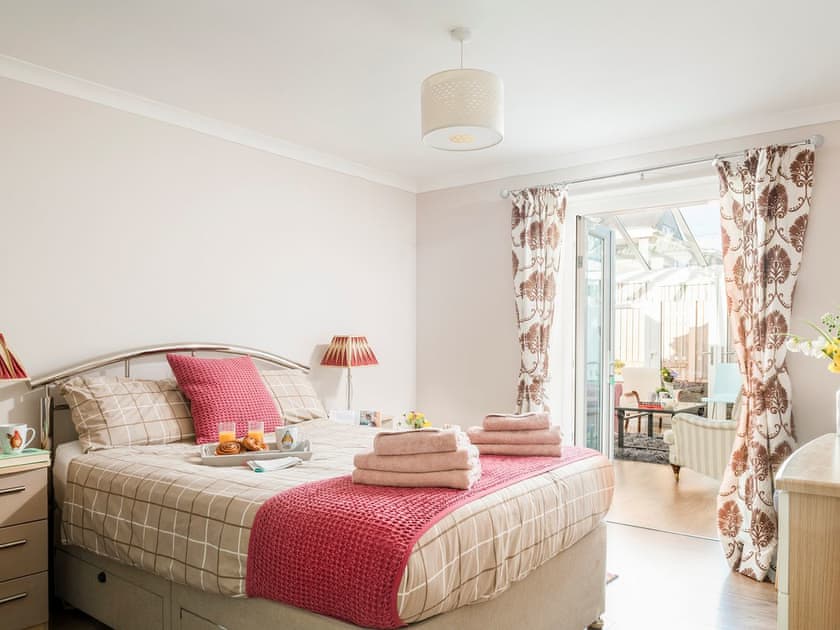 Double bedroom that leads into the conservatory | Dylmor, Benllech 
