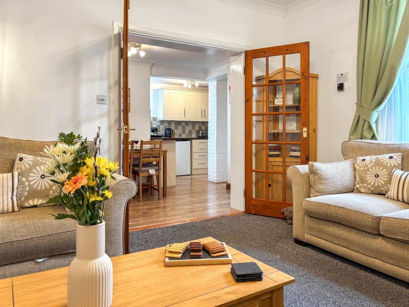 Comfortable living room with an open fireplace | Lavender Cottage, Keswick